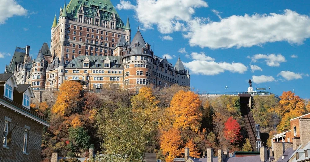 The Château Frontenac above autumn trees in Old Québec under a blue sky